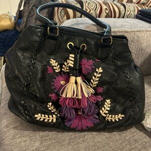 Elegant Black Leather Shoulder Bag with Purple and Cream Accents